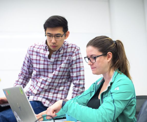 students looking at laptop